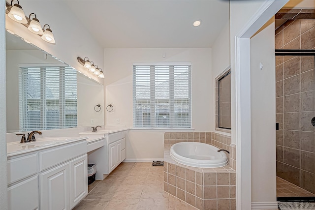 full bath with a bath, double vanity, a tile shower, and a sink