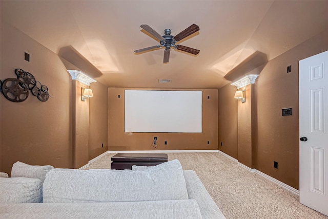 carpeted cinema room featuring decorative columns, lofted ceiling, visible vents, a ceiling fan, and baseboards