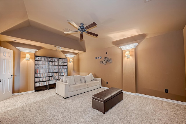 carpeted home theater room featuring baseboards, vaulted ceiling, and a ceiling fan