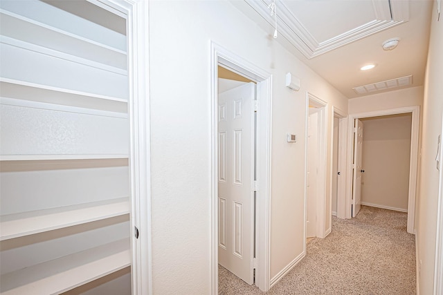 hallway with baseboards, recessed lighting, visible vents, and light colored carpet