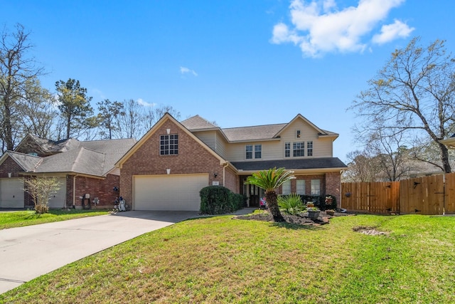 traditional-style home with concrete driveway, fence, brick siding, and a front lawn