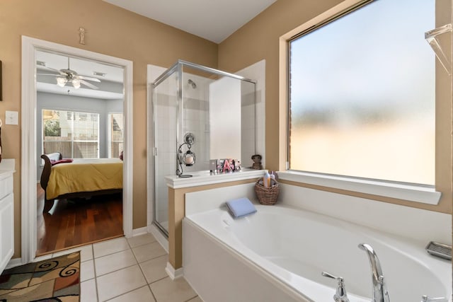 ensuite bathroom featuring tile patterned floors, a shower stall, ensuite bath, and a garden tub