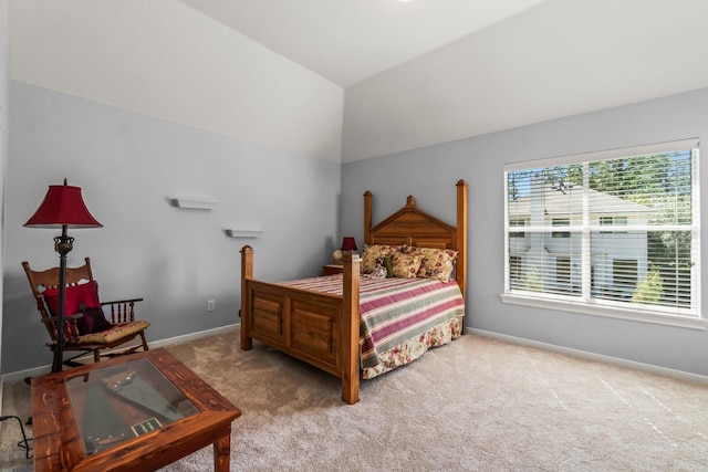 carpeted bedroom with vaulted ceiling and baseboards