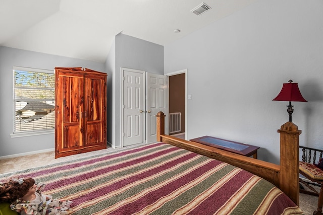 carpeted bedroom featuring vaulted ceiling, baseboards, visible vents, and a closet