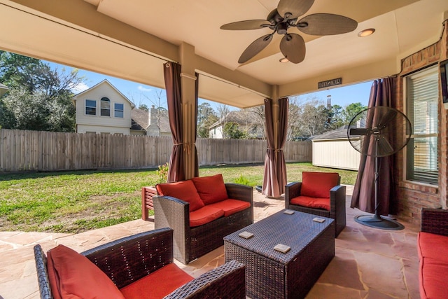 view of patio / terrace featuring a ceiling fan, an outdoor living space, and a fenced backyard