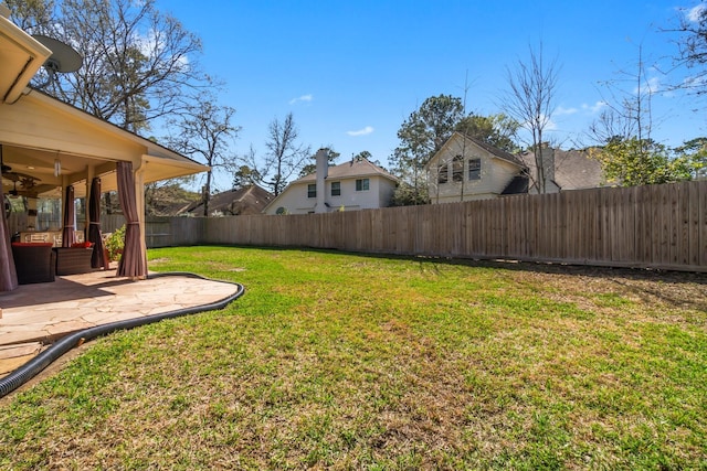 view of yard with a patio area and a fenced backyard