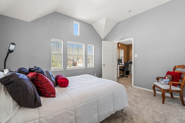 carpeted bedroom with lofted ceiling and baseboards