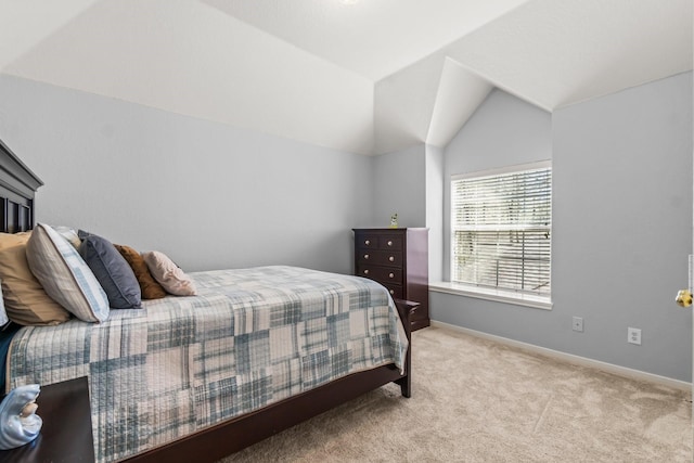 bedroom featuring lofted ceiling, carpet, and baseboards