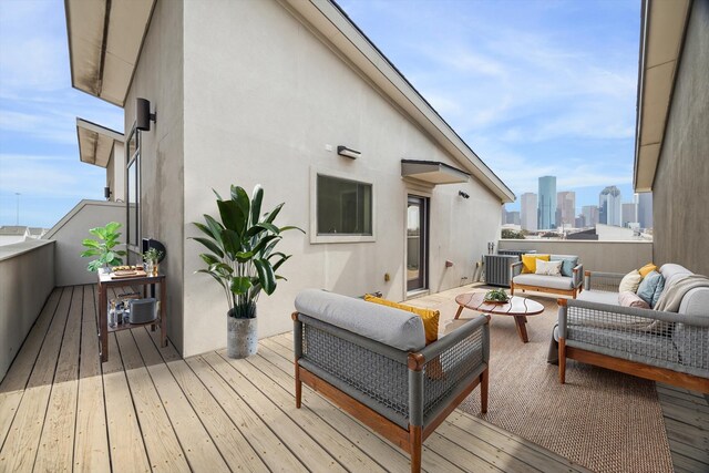 deck featuring a city view and an outdoor living space