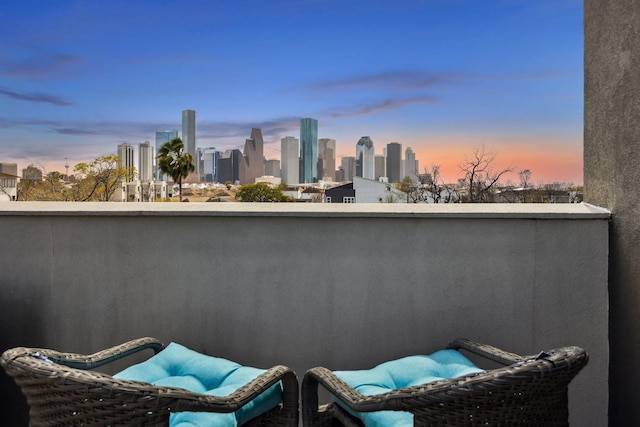 balcony at dusk with a city view