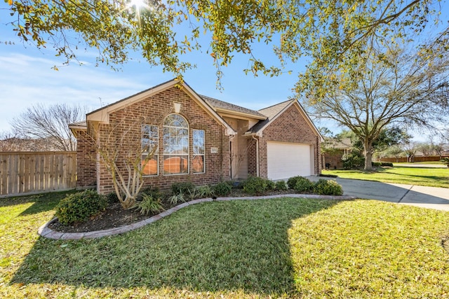 single story home with a front yard, fence, driveway, an attached garage, and brick siding