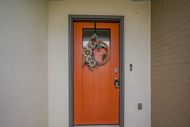 property entrance featuring stucco siding