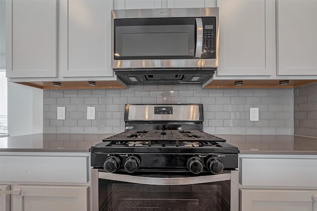 kitchen featuring tasteful backsplash, light countertops, appliances with stainless steel finishes, and white cabinets