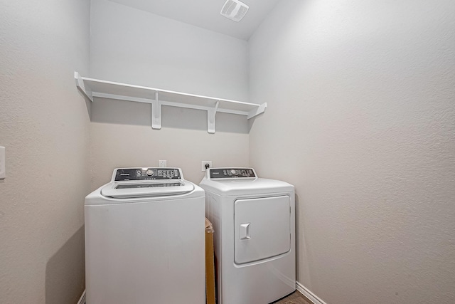 laundry area with laundry area, separate washer and dryer, and visible vents