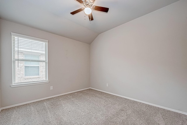 unfurnished room featuring vaulted ceiling, carpet flooring, a ceiling fan, and baseboards