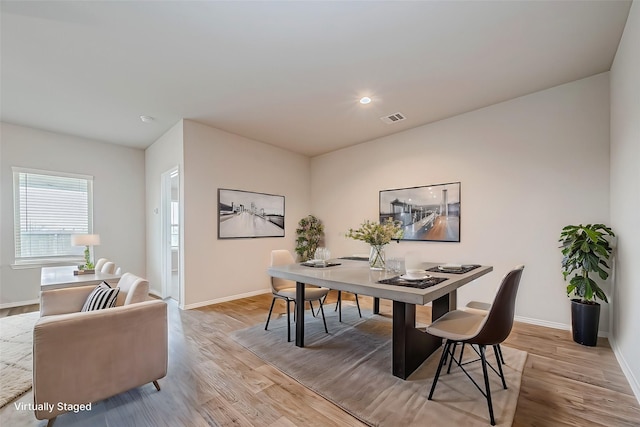 dining space with recessed lighting, light wood-type flooring, visible vents, and baseboards