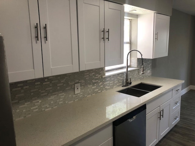 kitchen with a sink, white cabinetry, dark wood-style floors, decorative backsplash, and dishwasher