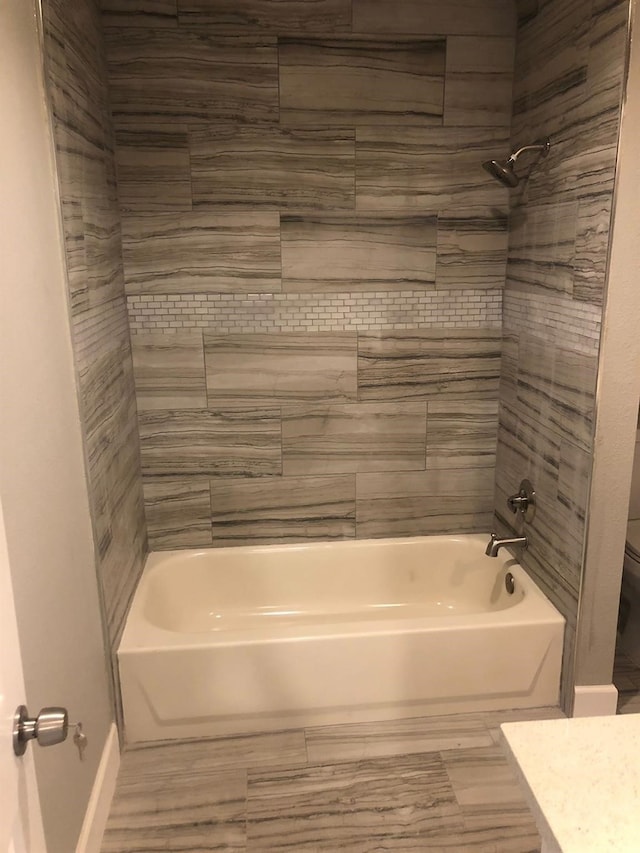 full bathroom featuring toilet, bathtub / shower combination, baseboards, and vanity