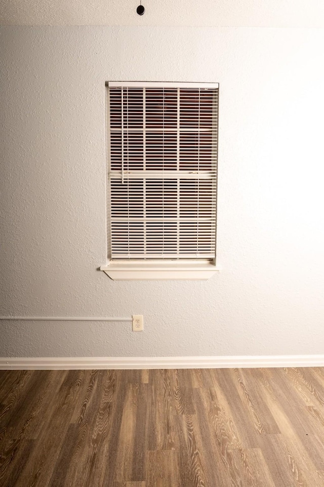 room details featuring visible vents, wood finished floors, and baseboards