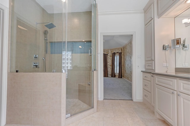 bathroom with vanity, a shower stall, baseboards, and tile patterned floors