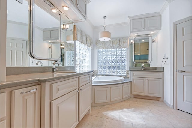 full bath featuring crown molding, a garden tub, two vanities, tile patterned floors, and a sink