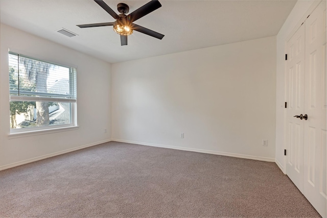 unfurnished bedroom with visible vents, ceiling fan, baseboards, carpet, and a closet