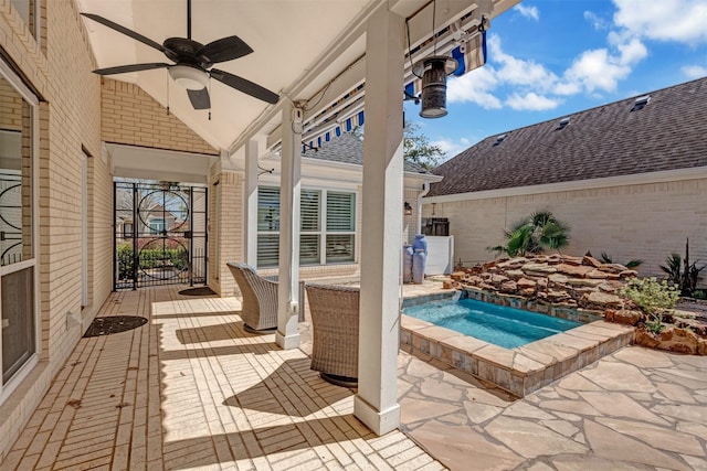 view of patio / terrace featuring an outdoor hot tub and ceiling fan