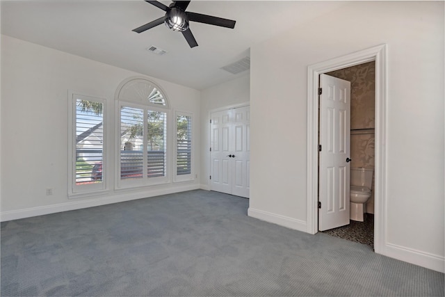 unfurnished bedroom featuring carpet flooring, baseboards, visible vents, and ceiling fan