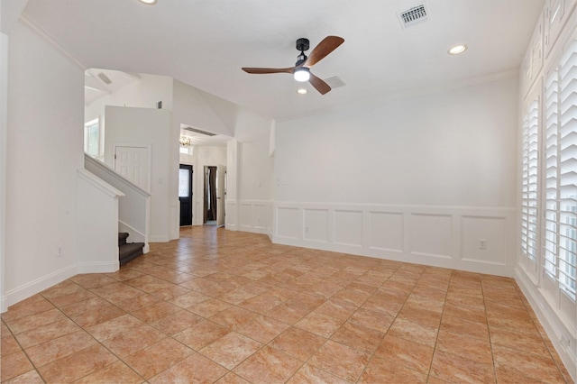 spare room featuring a wealth of natural light, visible vents, and a decorative wall