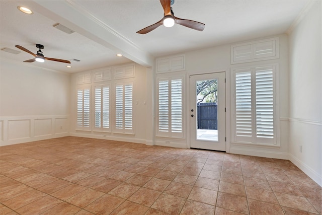 unfurnished room featuring crown molding, ceiling fan, beam ceiling, light tile patterned flooring, and a decorative wall