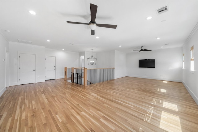 unfurnished living room with visible vents, ornamental molding, recessed lighting, light wood-style floors, and a ceiling fan