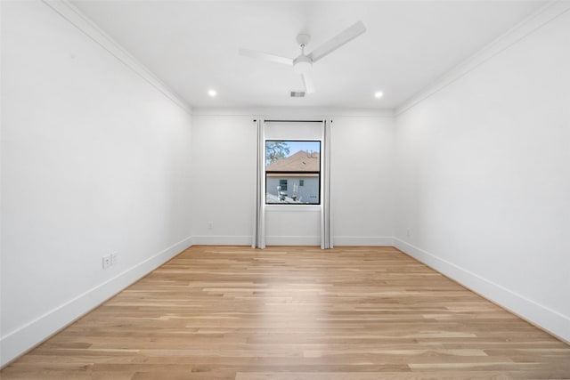 unfurnished room featuring visible vents, a ceiling fan, crown molding, and light wood-style floors