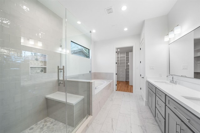 bathroom with visible vents, a stall shower, a sink, a bath, and marble finish floor