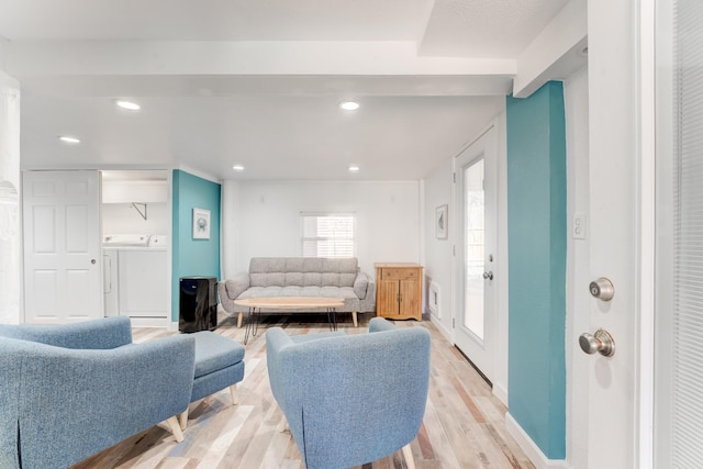 living room with washing machine and dryer, baseboards, light wood-style flooring, and recessed lighting