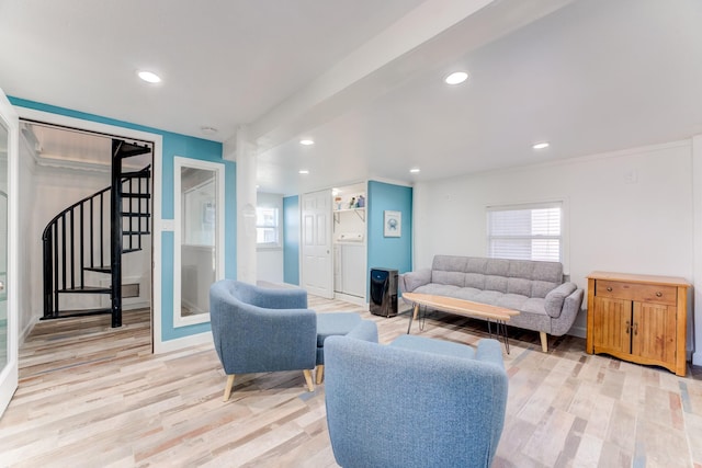 living area featuring stairs, light wood-type flooring, a wealth of natural light, and recessed lighting