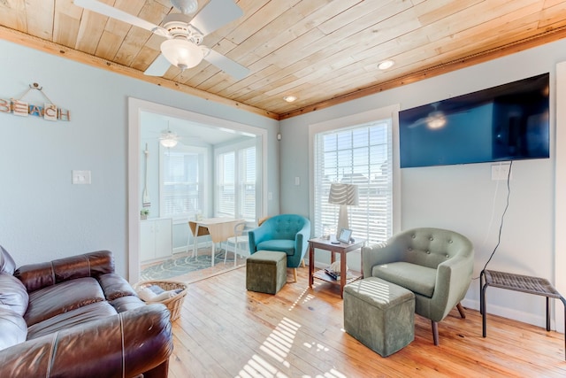 living room featuring wood ceiling, ceiling fan, light wood-style flooring, and baseboards