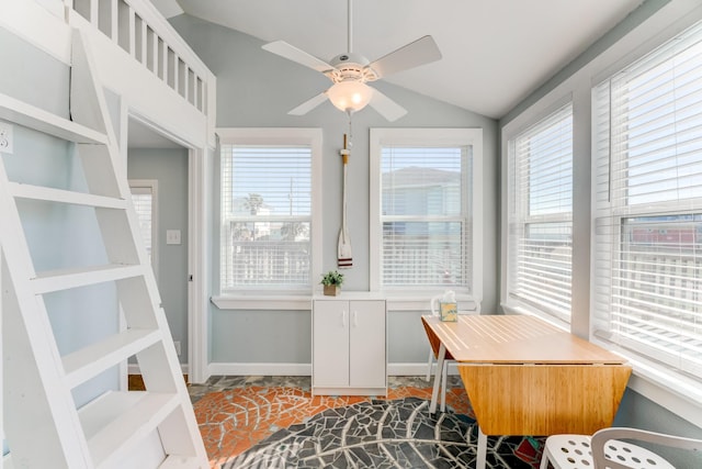 home office with lofted ceiling, baseboards, and a ceiling fan