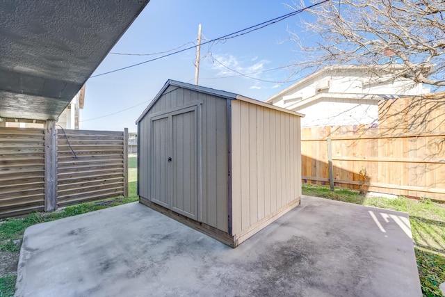 view of shed with a fenced backyard