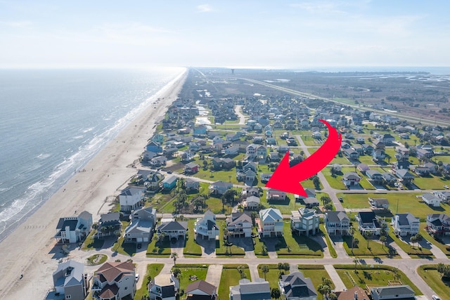 aerial view with a beach view, a residential view, and a water view