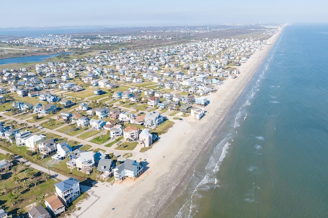 aerial view with a water view, a residential view, and a view of the beach