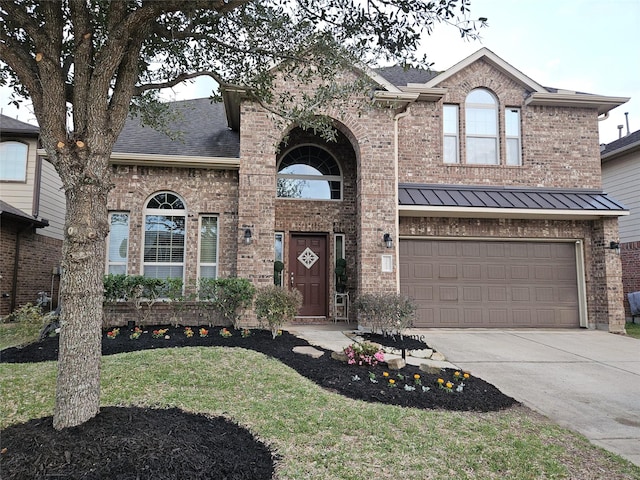 traditional-style home featuring a garage, brick siding, driveway, and a shingled roof