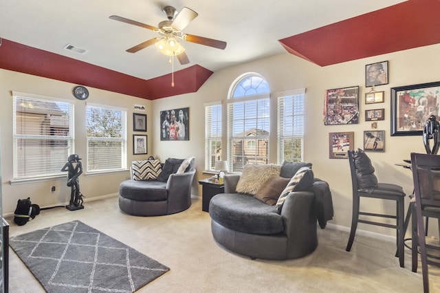 living room featuring carpet flooring, a ceiling fan, visible vents, and baseboards