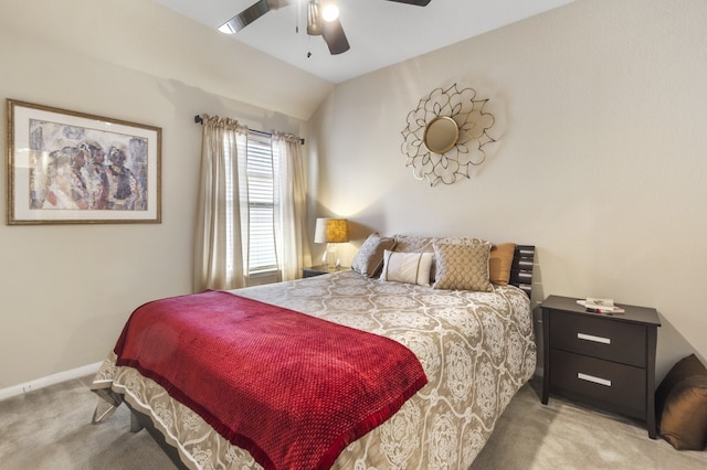 bedroom featuring baseboards, light carpet, ceiling fan, and vaulted ceiling