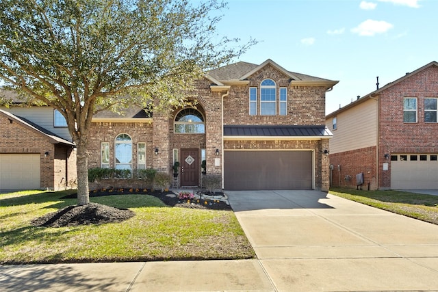 traditional-style house featuring driveway, a standing seam roof, a front yard, a garage, and brick siding