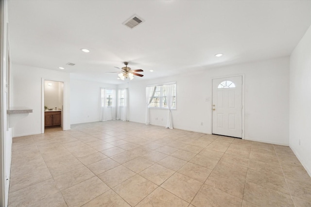 interior space featuring light tile patterned floors, recessed lighting, visible vents, a ceiling fan, and baseboards