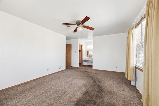 unfurnished bedroom featuring carpet floors, a ceiling fan, visible vents, and baseboards