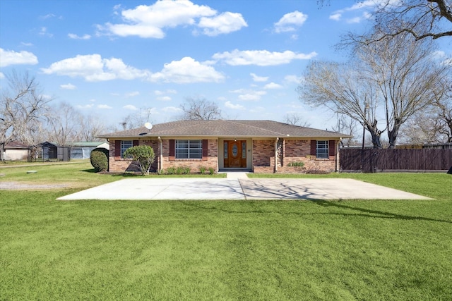 view of front of house featuring brick siding, a front yard, and fence