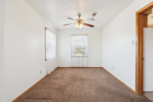 unfurnished room with baseboards, visible vents, ceiling fan, and carpet flooring