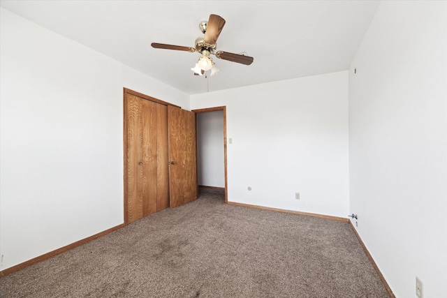 unfurnished bedroom featuring a closet, carpet, a ceiling fan, and baseboards