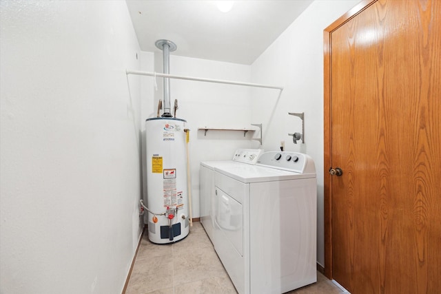 clothes washing area with gas water heater, light tile patterned flooring, laundry area, independent washer and dryer, and baseboards